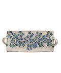 Decorative ceramic tray with blue floral pattern on a beige background