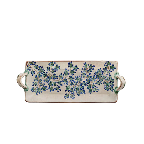 Decorative ceramic tray with blue floral pattern on a beige background