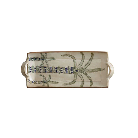 Ceramic tray with decorative handles and palm tree design on a beige background