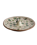 Ceramic dish with a decorative pattern on a beige background