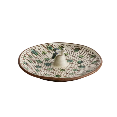 Ceramic dish with a decorative pattern on a beige background