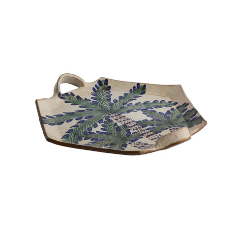 Ceramic tray with leaf pattern on a beige background